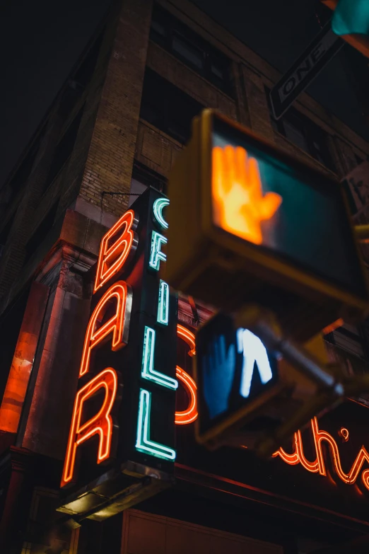 a traffic light hanging from the side of a building, by Chris Rallis, unsplash contest winner, graffiti, dimly lit dive bar, fireball hand, times square, ball