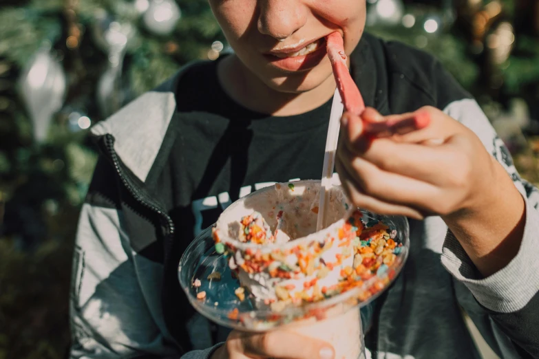 a boy eating an ice cream sundae with sprinkles, pexels contest winner, teenage, background image, people outside eating meals, close up to a skinny