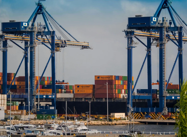 a harbor filled with lots of boats under a blue sky, by Tom Wänerstrand, pexels contest winner, shipping containers, avatar image, huge machine cranes, australia