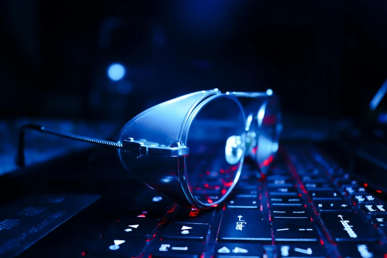 a pair of glasses sitting on top of a computer keyboard, a computer rendering, unsplash, holography, deep blue lighting, cybersteampunk, avatar image, low-angle shot