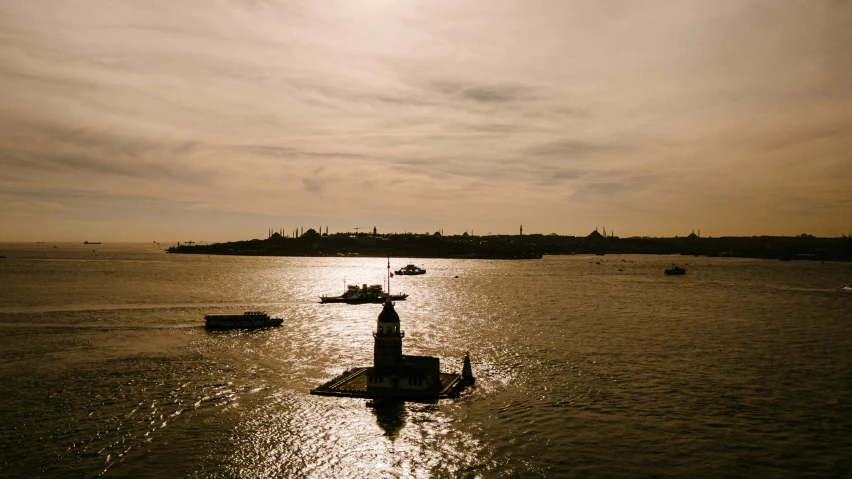 a statue in the middle of a body of water, by Tobias Stimmer, pexels contest winner, hurufiyya, istanbul, late afternoon sun, wide high angle view, 2000s photo