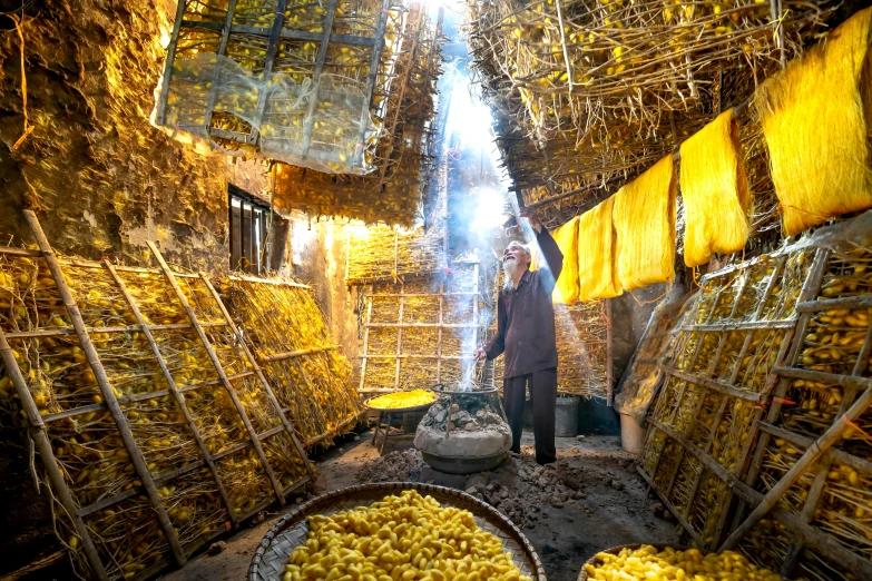 a man standing next to a pile of bananas, by Julia Pishtar, unsplash contest winner, in a massive cavernous iron city, with yellow cloths, inside house in village, sichuan