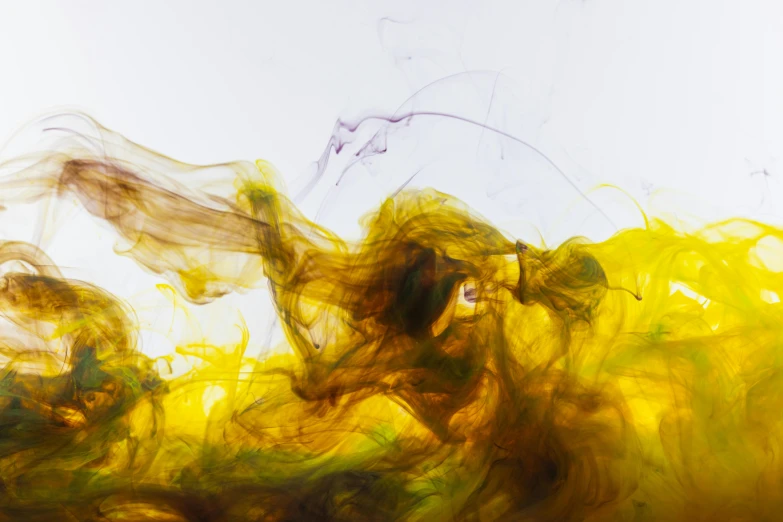 a close up of a yellow substance on a white surface, by Thomas Häfner, pexels, yellow purple green black, liquid smoke, ocher, ignant