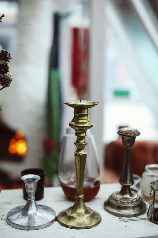 a group of candles sitting on top of a table, brass beak, full of details, fine dining, zoomed in