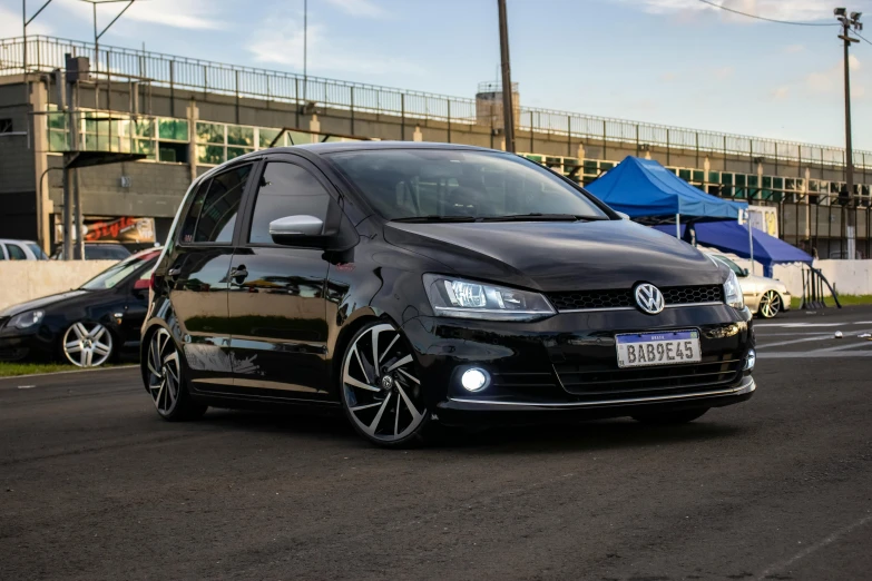 a black vw golf parked on the side of the road, a picture, by Felipe Seade, on a street race track, avatar image, low iso, concert