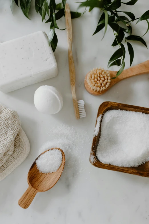 a couple of wooden spoons sitting on top of a counter, a still life, trending on pexels, bubble bath, white salt, greens, thumbnail