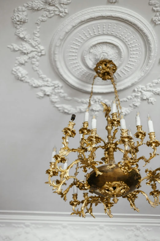 a chandelier hanging from the ceiling in a room, pexels contest winner, baroque, white with gold accents, recessed, white background, museum lighting