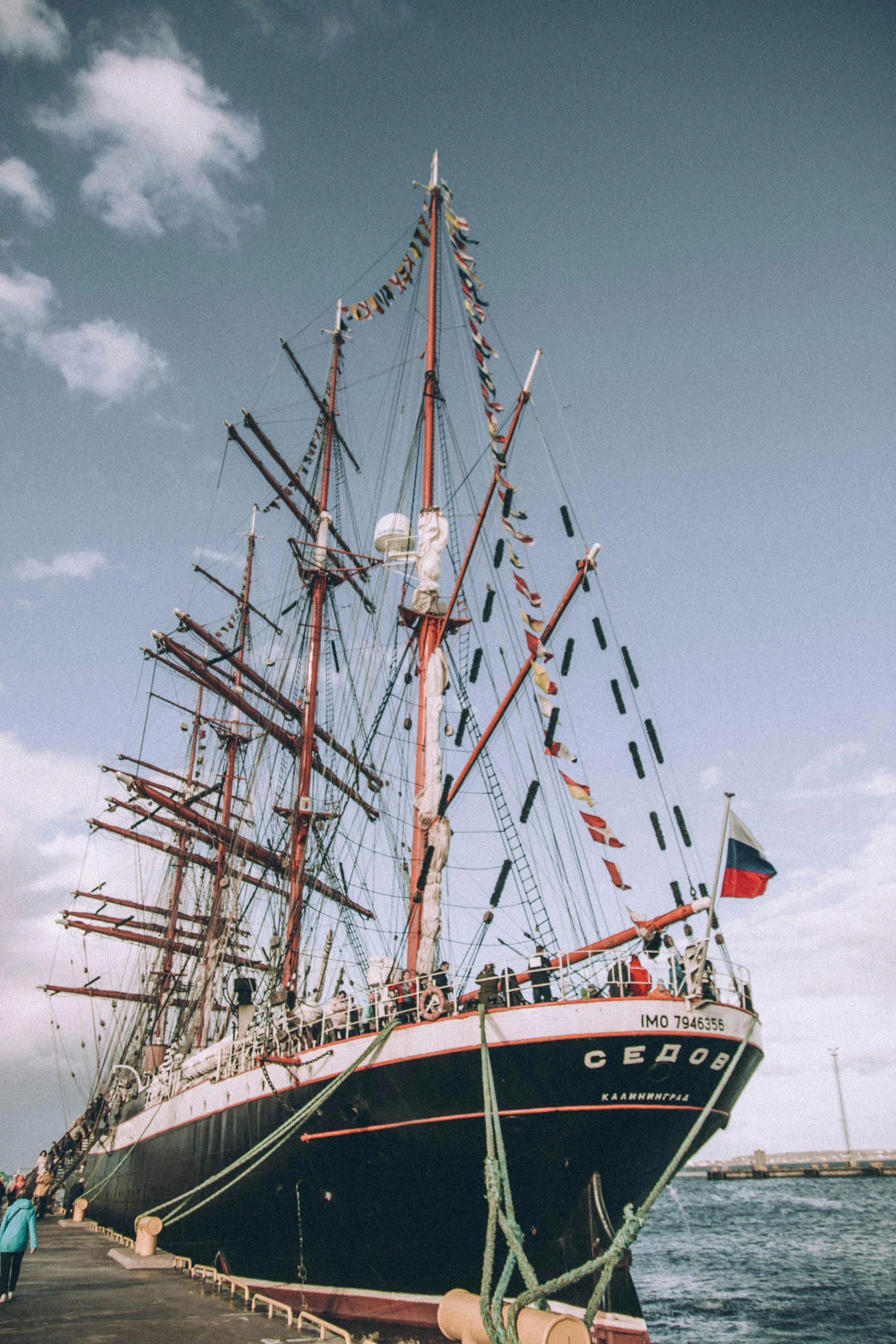 a large boat sitting on top of a body of water, an album cover, inspired by Vasily Surikov, pexels contest winner, standing on the mast, czeslaw znamierowski, replica model, chile