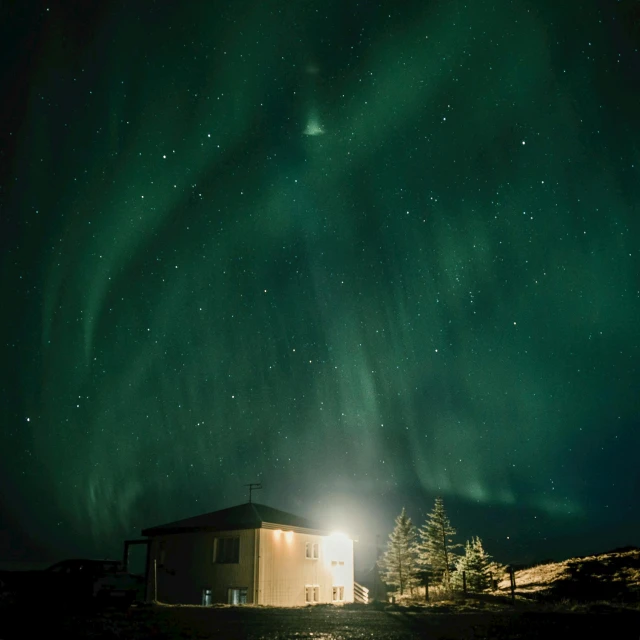 the aurora bore lights up the night sky above a cabin, pexels contest winner, light and space, shot on hasselblad, high quality photo, concept photo, distant photo