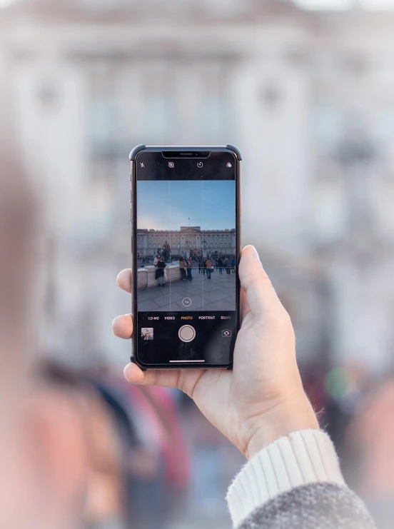 a person taking a picture with their cell phone, a picture, pexels contest winner, in a city square, frontal picture, high resolution image, iphone video