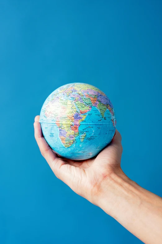 a person holding a small globe in their hand, slide show, multicoloured, thumbnail, blue