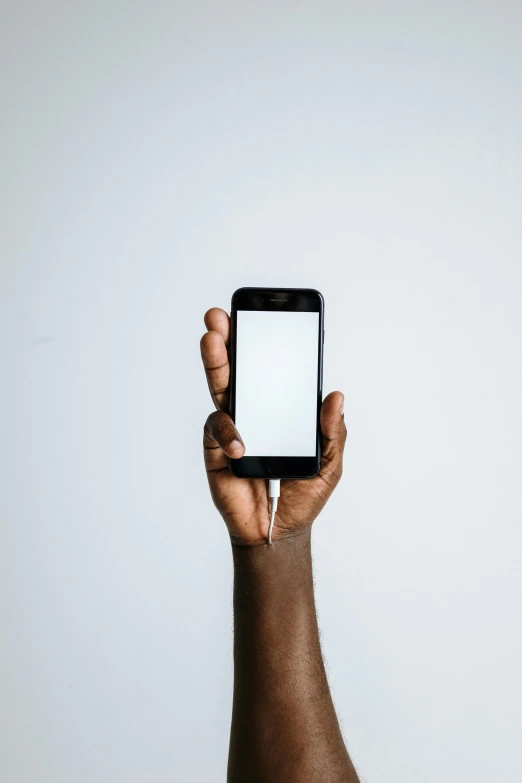 a person holding a smart phone in their hand, by James Morris, trending on pexels, black on white background, afro tech, square, rectangle