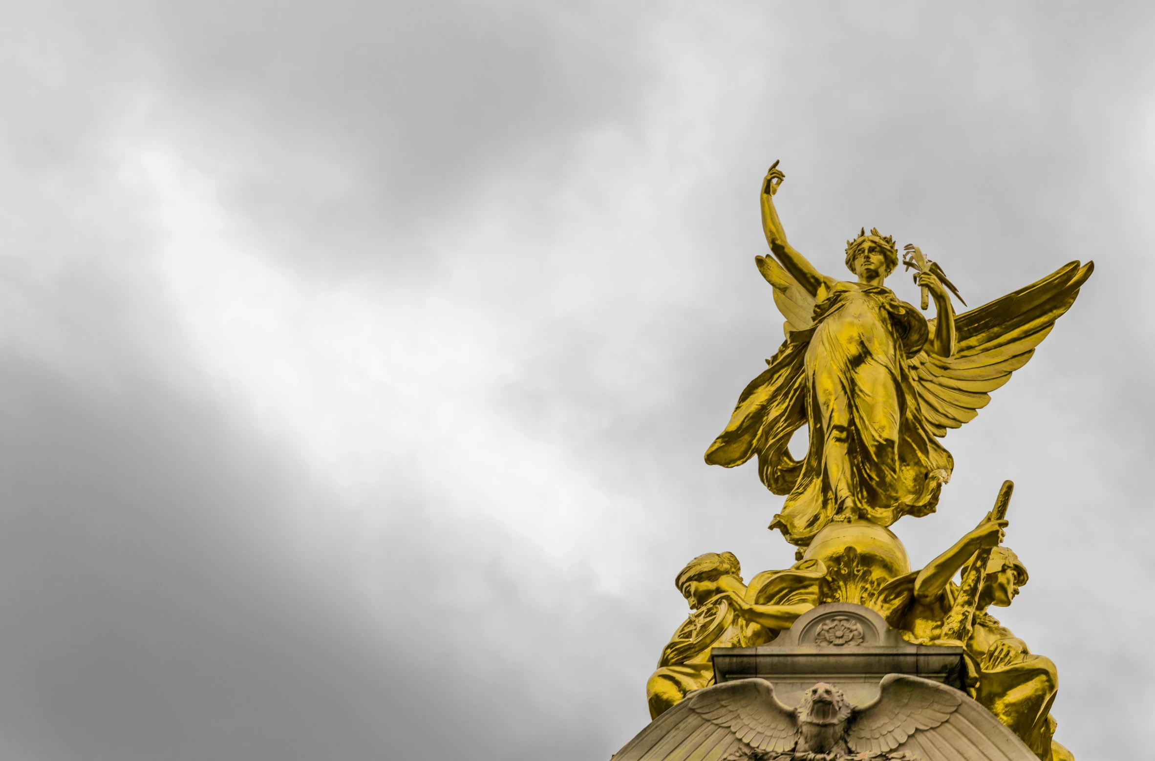 a statue of an angel on top of a building, inspired by Alexandre Falguière, pexels contest winner, neoclassicism, ornate gold crown, interior of buckingham palace, draped in shiny gold and silver, the style of rococo