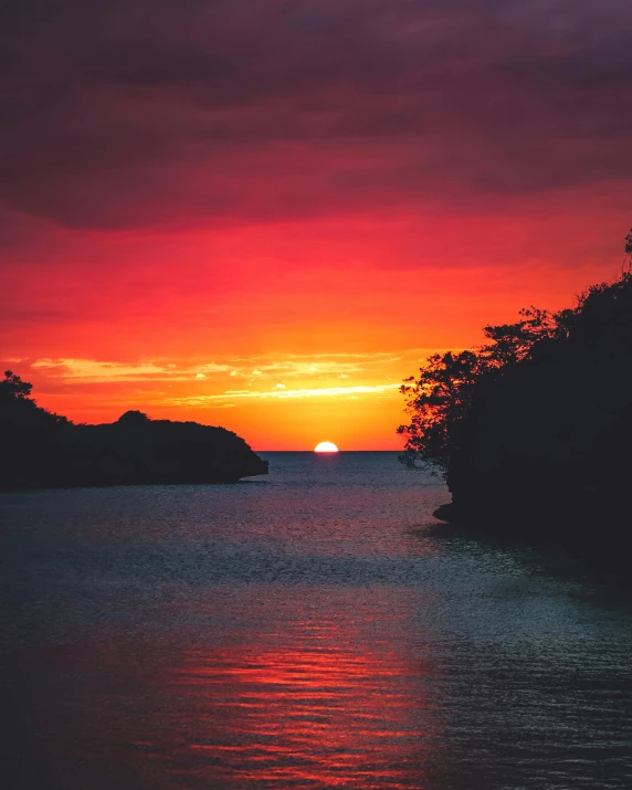 the sun is setting over a body of water, pexels contest winner, sumatraism, lgbtq, puerto rico, red hues, instagram post