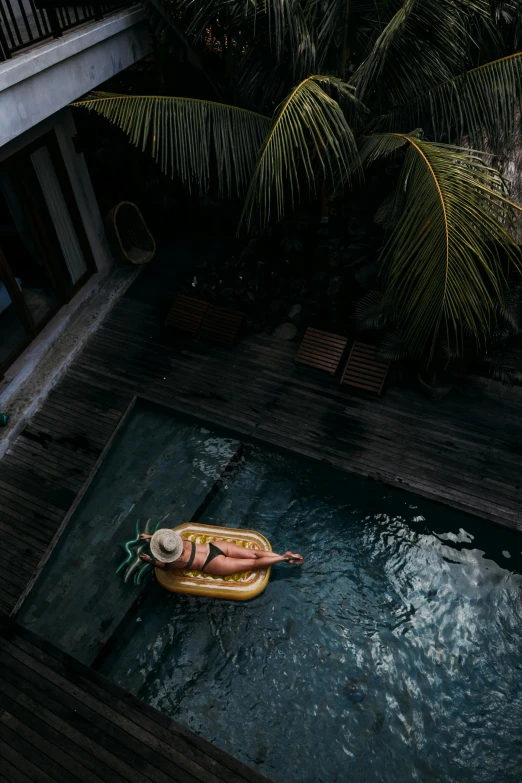a small boat floating on top of a pool, inspired by Elsa Bleda, unsplash contest winner, bali, slate, inflatable, 3 0 years old woman