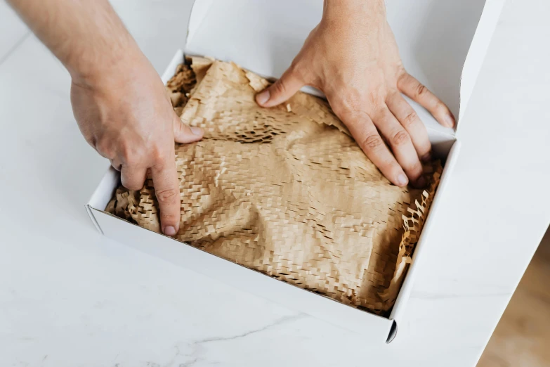 a close up of a person opening a box of food, paper crumpled texture, detailed product image, half turned around, handcrafted