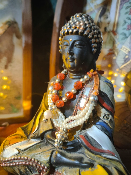 a statue of a buddha sitting on top of a table, jewelry pearls, bay area, profile image, vibrant aesthetic