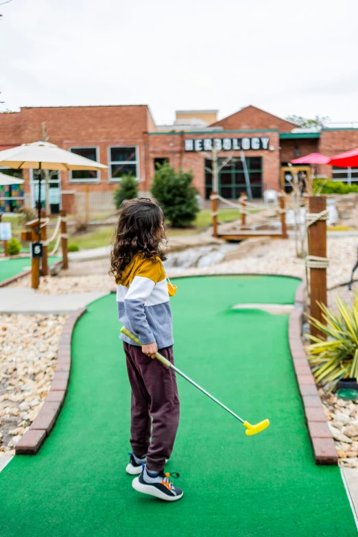 a little girl standing on top of a miniature golf course, hobbithead, explore, thumbnail, corduroy