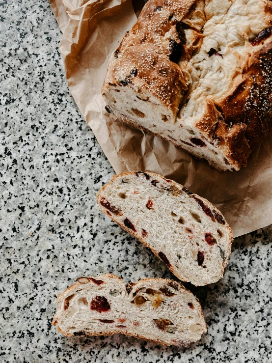 a loaf of bread sitting on top of a piece of paper, unsplash, baroque, garnet, terrazzo, award - winning crisp details ”, large tall