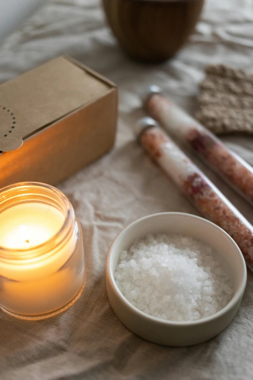 a couple of candles sitting on top of a table, inspired by Eden Box, unsplash, renaissance, white salt, ingredients on the table, brown, medium close up