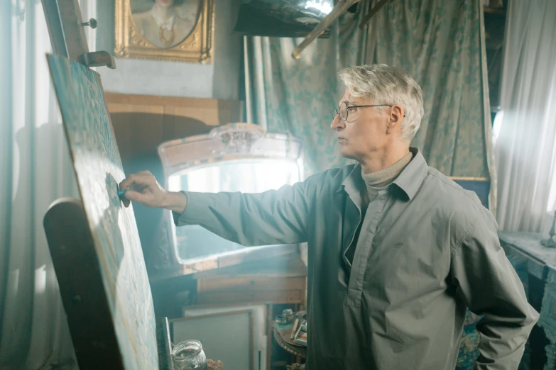 a man standing in front of a painting on a easel, pexels, hyperrealism, an oldman, still from a live action movie, thomas kindkade, de kooning