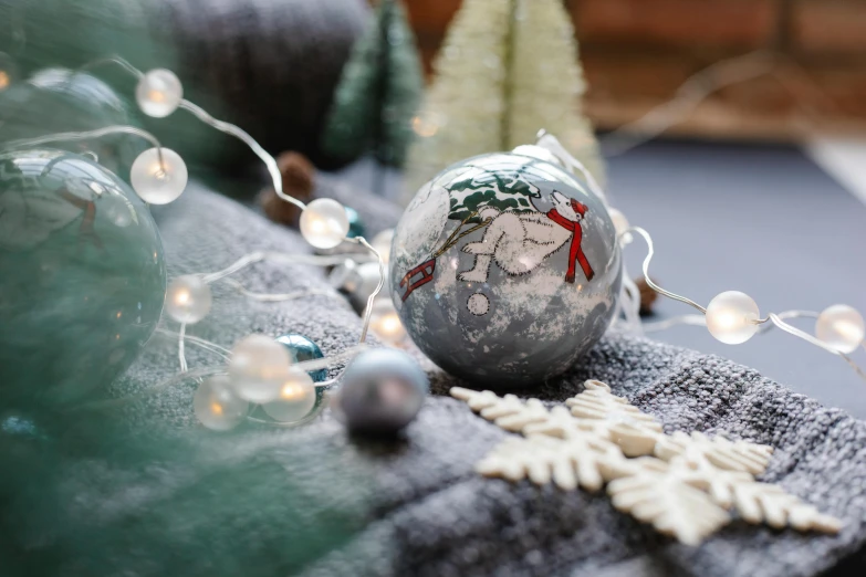 a close up of a christmas ornament on a table, inspired by Ernest William Christmas, happening, grey, winter scene, large globe, frosty