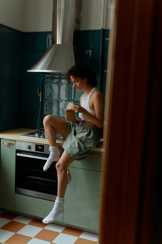 a man sitting on a counter in a kitchen, a picture, inspired by Elsa Bleda, trending on pexels, anna nikonova aka newmilky, ashteroth, full body model, ignant