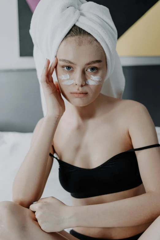 a woman sitting on a bed with a towel on her head, by Cosmo Alexander, trending on pexels, renaissance, square facial structure, silicone skin, gif, perfect face )