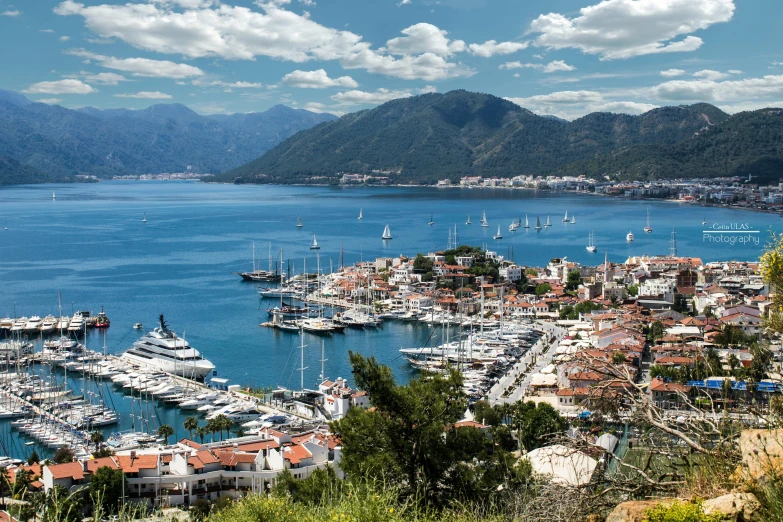 a large body of water filled with lots of boats, pexels contest winner, art nouveau, turkey, picton blue, conde nast traveler photo, mountains and ocean