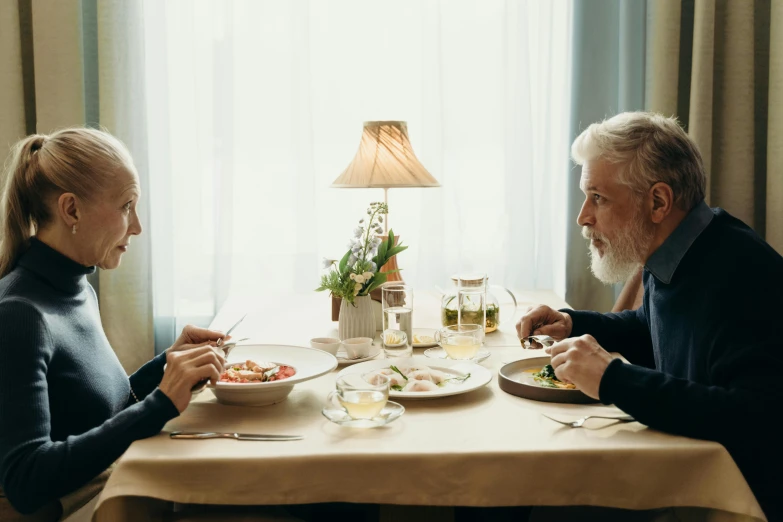 a man and a woman sitting at a table eating, unsplash, fantastic realism, silver hair and beard, oscar winning, offering a plate of food, dardenne brothers