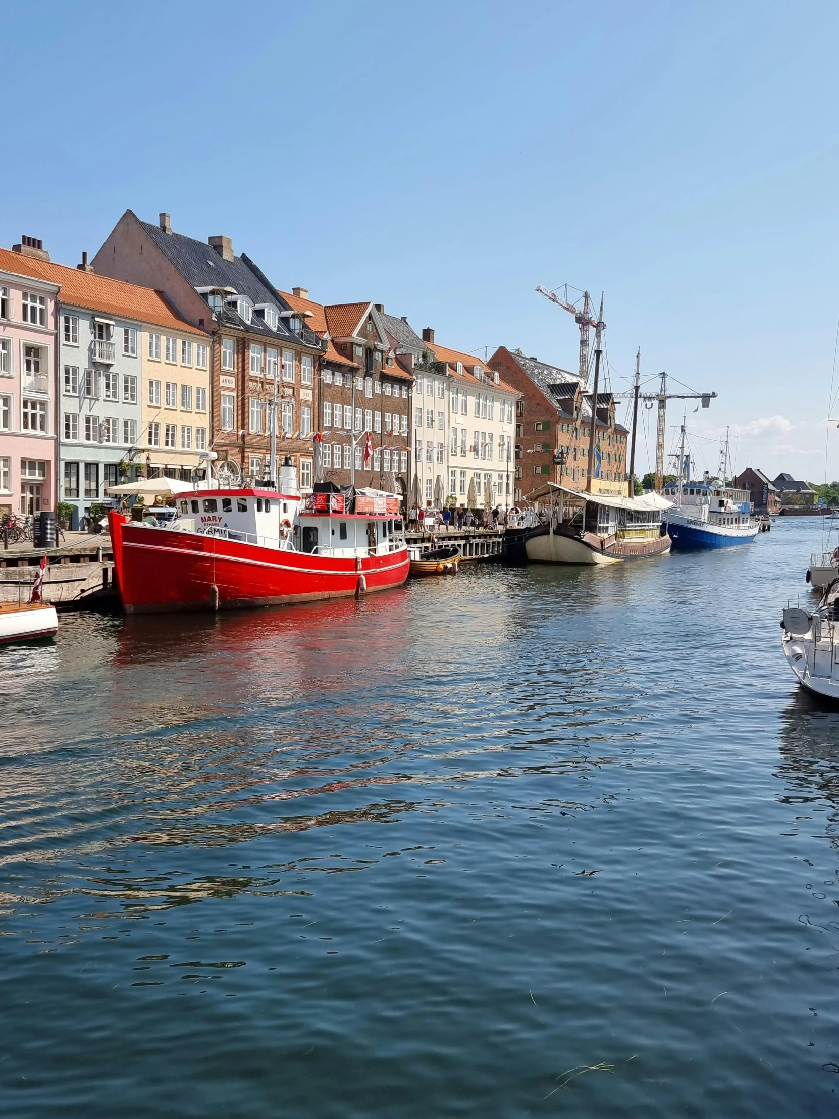 a number of boats in a body of water, by Christen Dalsgaard, pexels contest winner, hurufiyya, white buildings with red roofs, with a long, canal, bright summer day