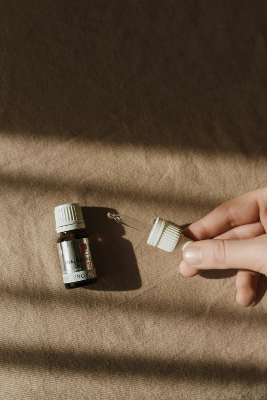 a person holding a toothbrush next to a bottle of toothpaste, by Emma Andijewska, seeds, photograph from above, mini figure, soft shade