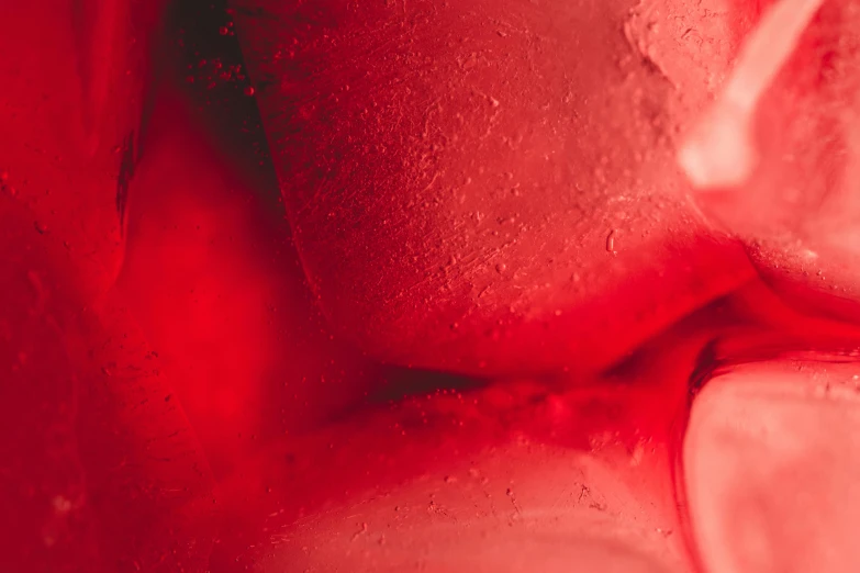 a close up of some ice cubes on a table, a macro photograph, inspired by Hans Erni, visual art, sexy red lips, covered in red slime, from a huge red glass bong, lovers melting into bed