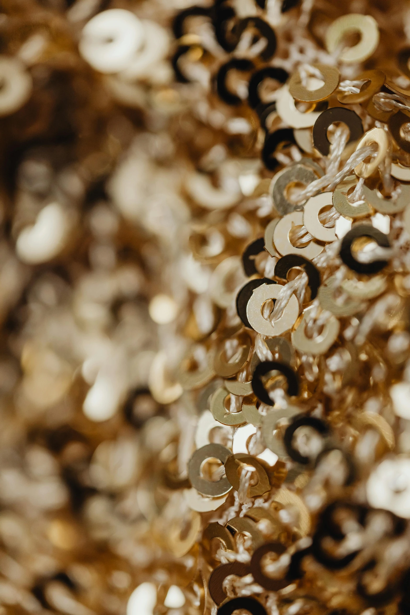 a close up of a bunch of gold sequins, by Nina Hamnett, baroque, made in gold, swirling, lightweight, detailed product shot