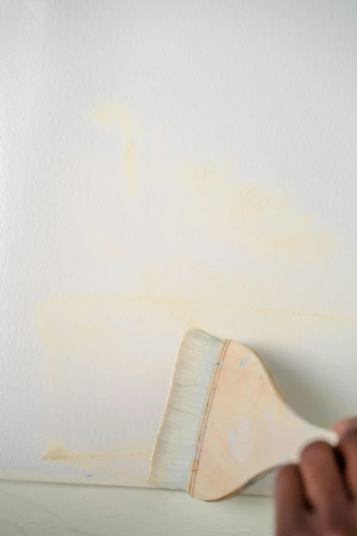 a person painting a wall with a paint brush, inspired by Clarice Beckett, faded chipped paint, gradient light yellow, -step 50, curvilinear pencil marks