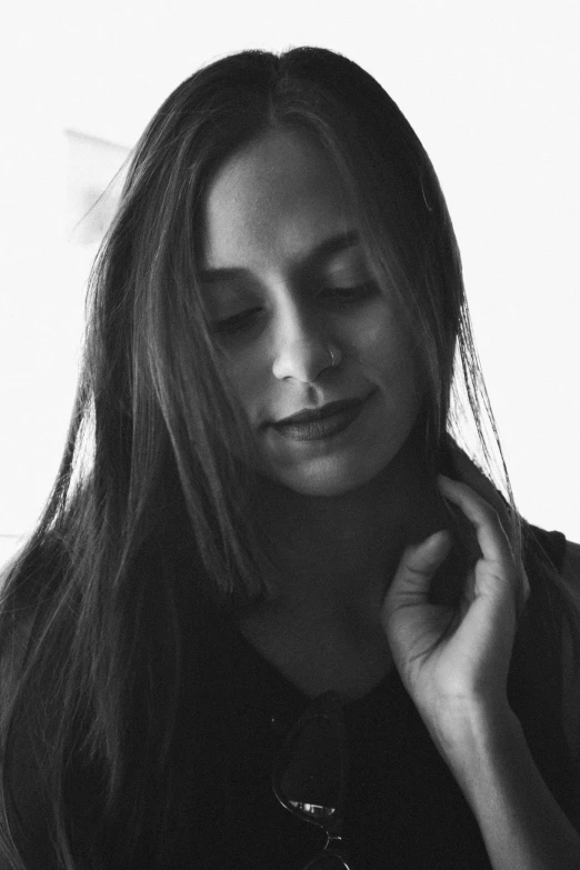 a black and white photo of a woman with long hair, antipodeans, faridah malik, peaceful expression, noseless, portait image