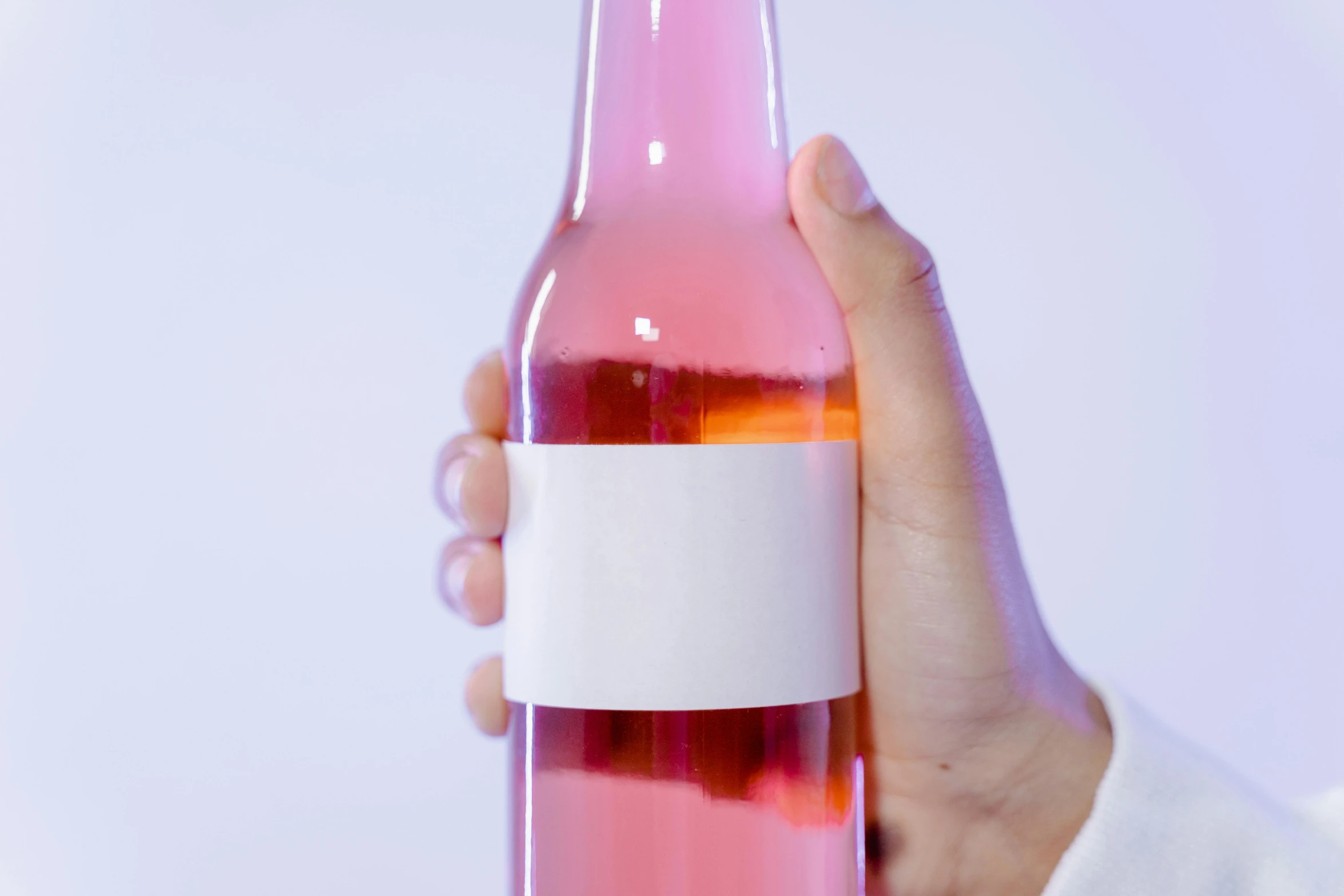 a person holding a bottle of pink wine, unsplash, made of lab tissue, syrup, on clear background, dezeen