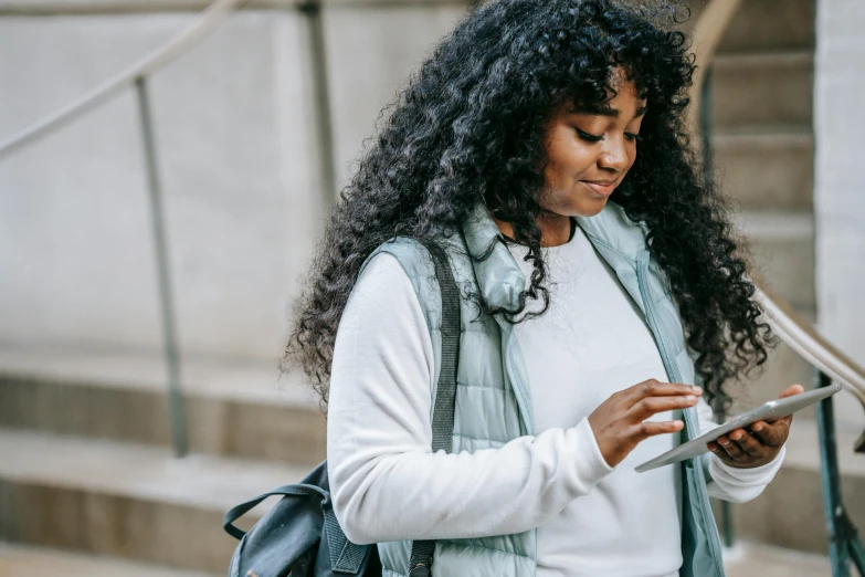 a woman with curly hair using a cell phone, by Carey Morris, trending on pexels, avatar image, student, female with long black hair, black female