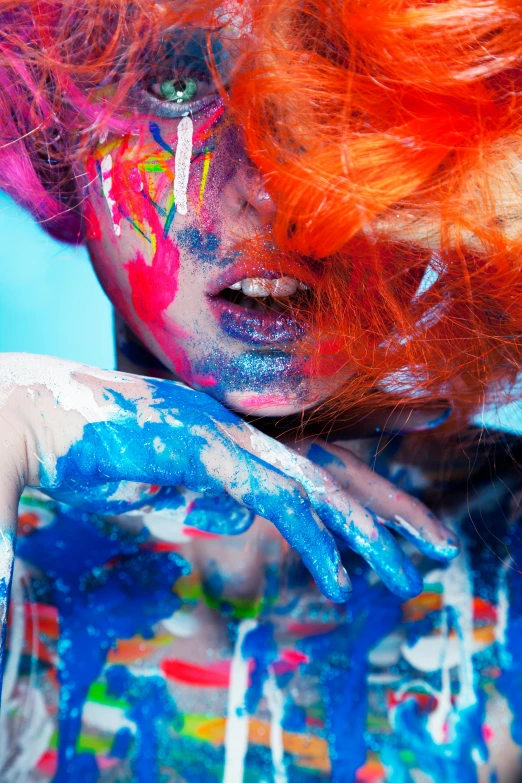 a close up of a person with paint on their face, inspired by LeRoy Neiman, trending on pexels, art photography, blue and red hair, orange hair, an orgy of colorful, ilustration