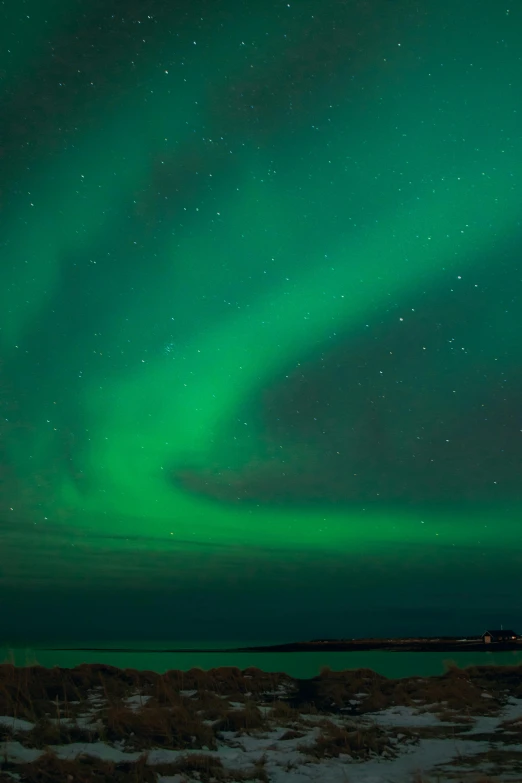 the northern lights in the sky above a body of water, dramatic lighting - n 9, reykjavik, bright green dark orange, christopher alexander