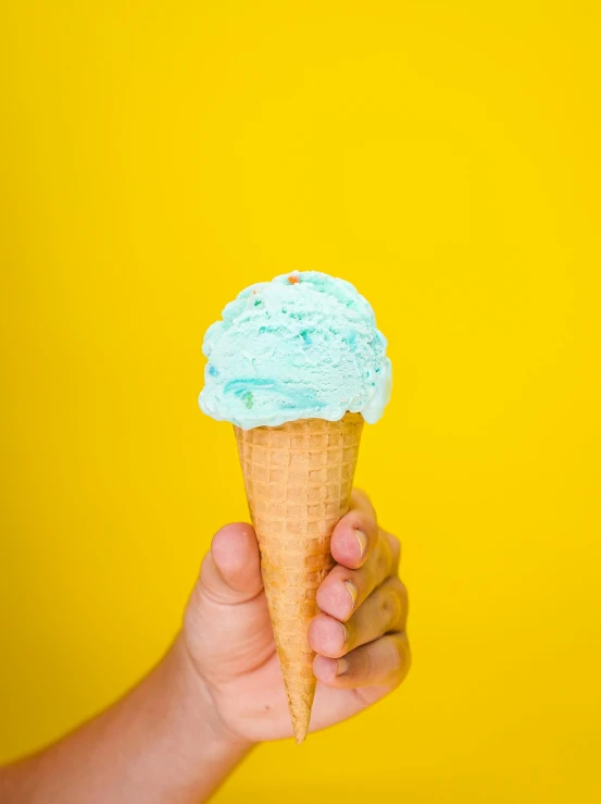 a person holding an ice cream cone in their hand, ice blue, sulfur, gooey skin, ((blue))