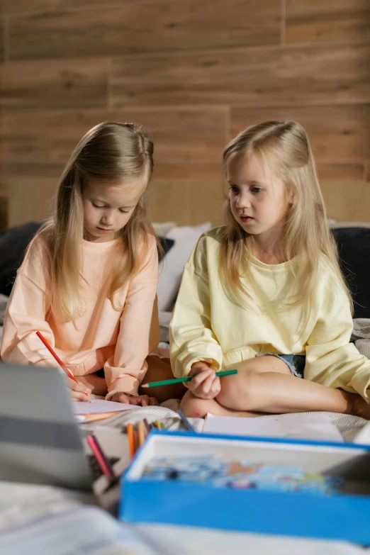 a couple of young girls sitting on top of a bed, a child's drawing, pexels, programming, multiple stories, a blond, gif