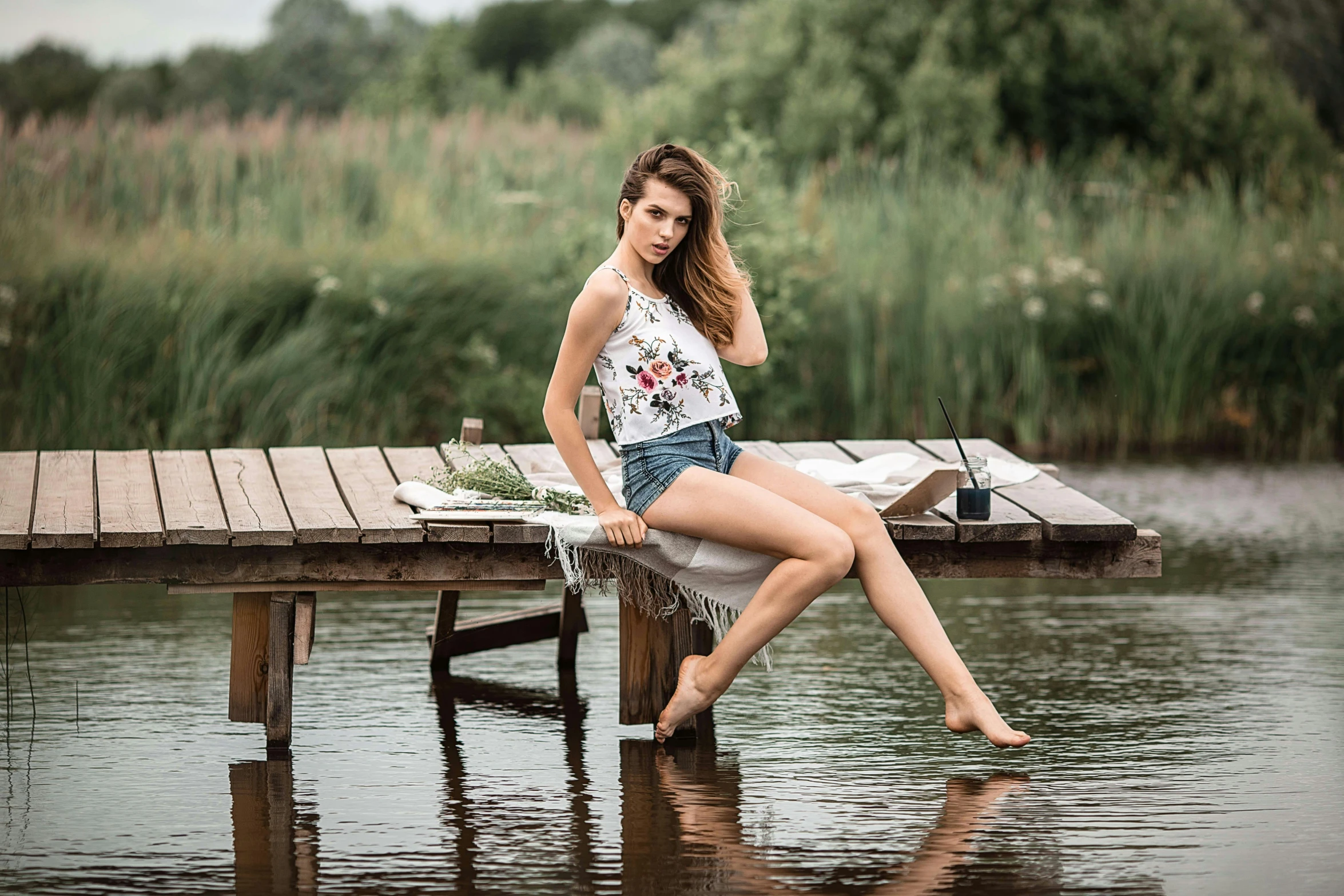 a woman sitting on a dock next to a body of water, a portrait, by Antoni Brodowski, pexels contest winner, renaissance, white! tank top with a print, ukrainian girl, sitting on the table, very beautiful slim legs