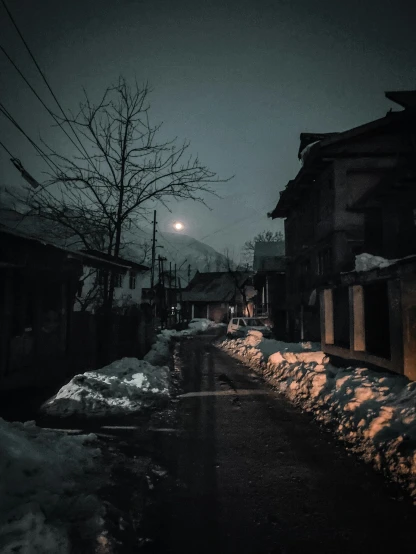 a snowy street at night with a full moon in the sky, an album cover, pexels contest winner, mingei, moonlit kerala village, icy cold pale silent atmosphere, dark abandoned city streets, japanese rural town