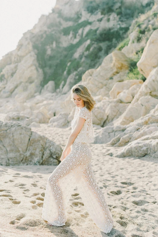 a woman standing on top of a sandy beach, intricate and detailed lace set, sydney sweeney, curated collections, “ ethereal