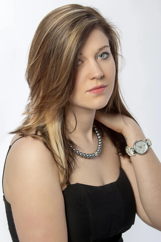 a woman in a black dress posing for a picture, headshot photography, laura sava, casual pose, jewelry