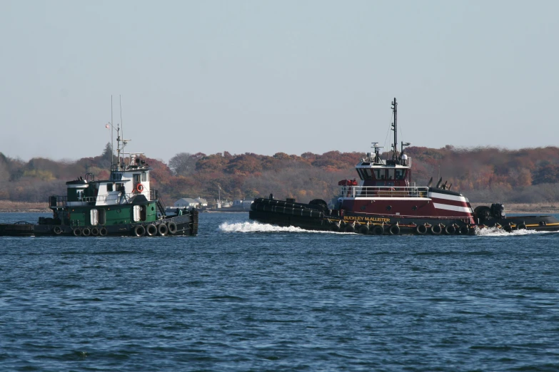 a couple of boats that are in the water, by Pamela Drew, pexels, hurufiyya, new york harbour, dredged seabed, thumbnail, 8k octan photo