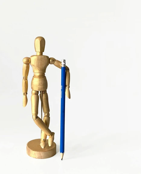 a wooden mannequin holding a blue pencil, inspired by Sarah Lucas, new sculpture, detailed product image, sassy pose, ilustration, product introduction photo