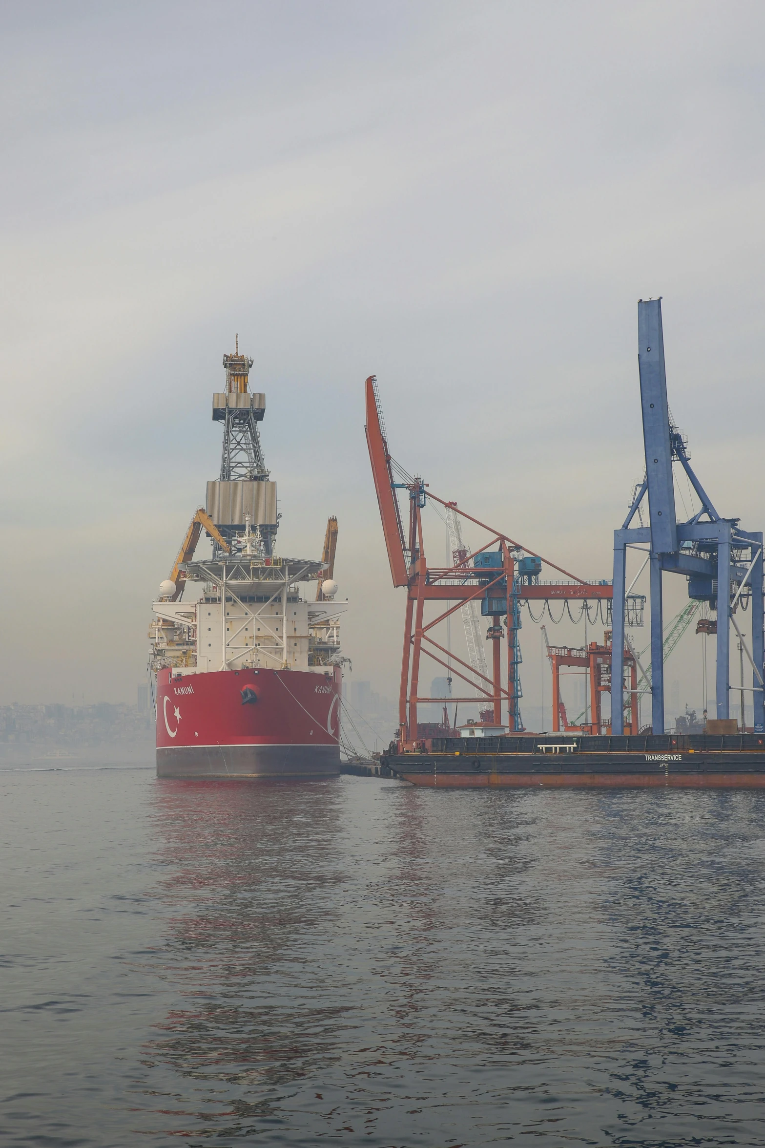 a large boat sitting on top of a body of water, cranes, on the sea, chile, mechanical superstructure