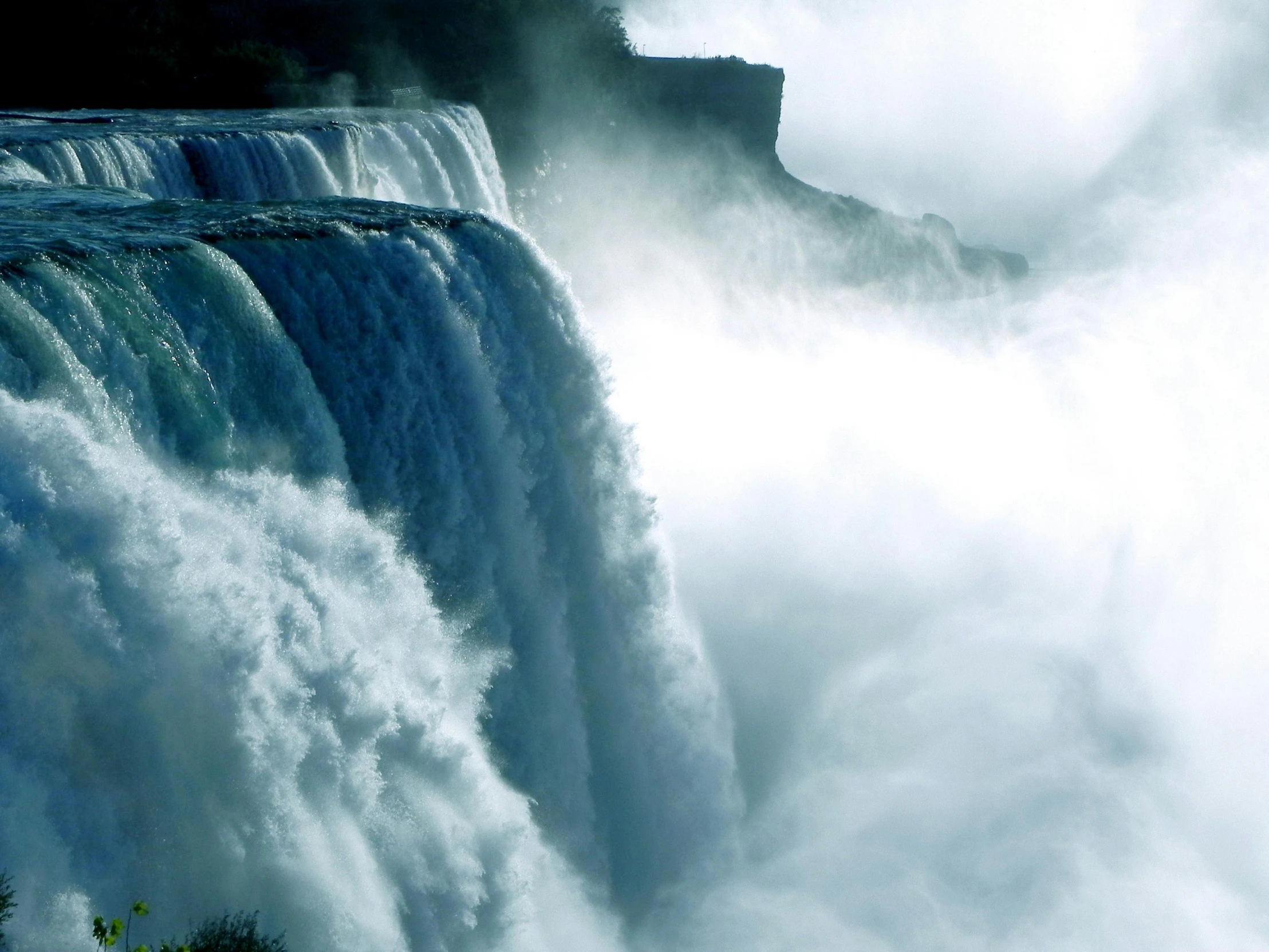 a large waterfall in the middle of a forest, pexels contest winner, hurufiyya, niagara falls, wall of water either side, hazy water, thumbnail